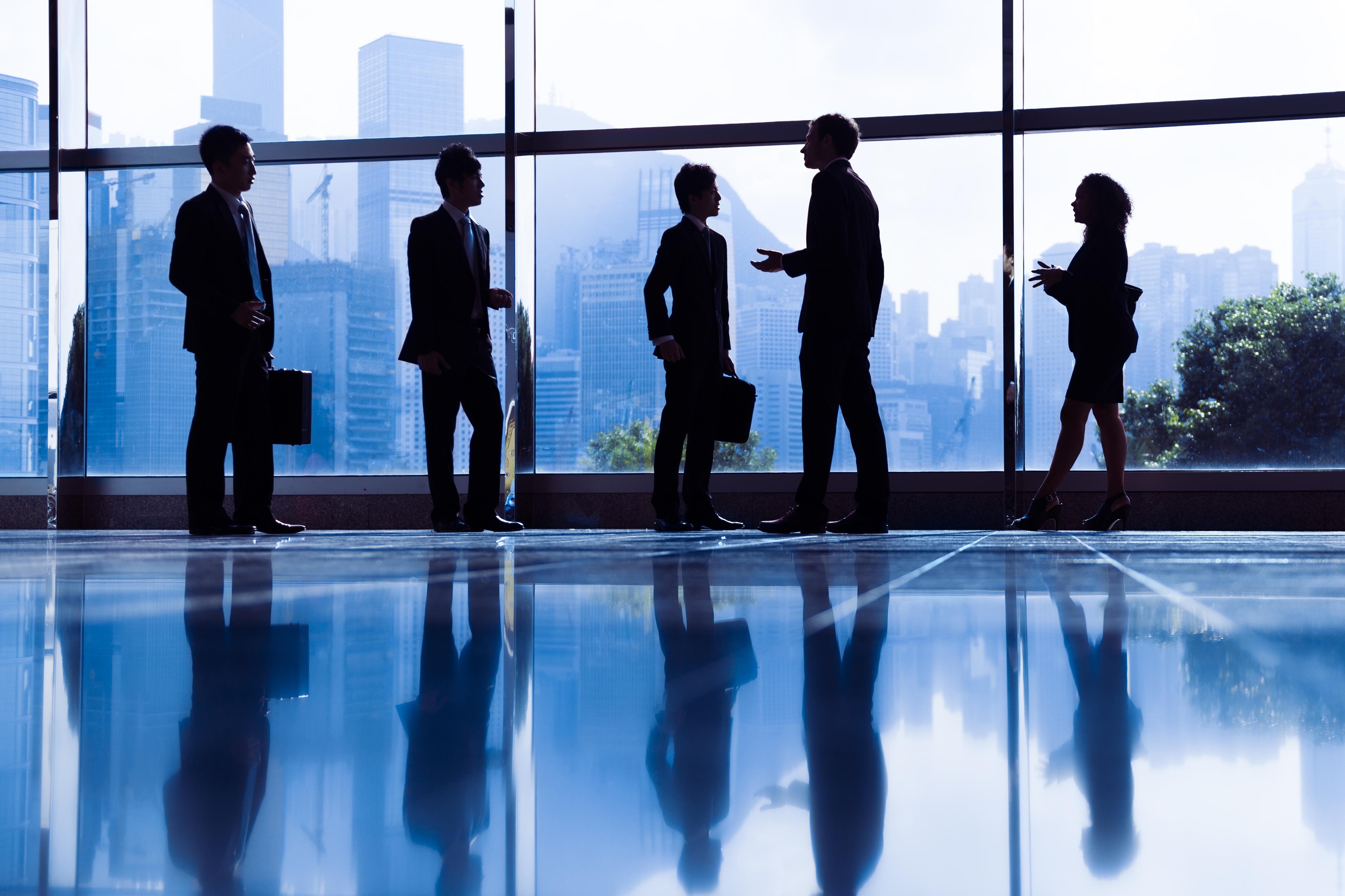 business people meeting in hallway